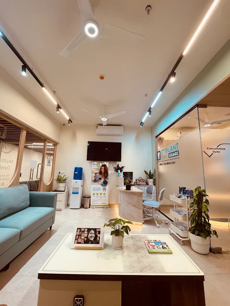 Implant Square reception with teal sofa, coffee table, marble reception desk, and glass partition labeled Consultation Suite with clinic branding.